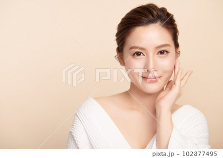 Beautiful young asian woman with clean fresh skin on beige background, Face care, Facial treatment, Cosmetology, beauty and spa, Asian women portrait. Beautiful young asian woman with clean fresh skin on beige background, Face care, Facial treatment, Cosmetology, beauty and spa, Asian women portrait. 102877495