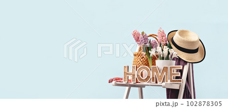 Home word. Several spring pink hyacinth flower plants potted on garden chair. Hat and apron. Flowerhead in bloom. Home Garden plants banner Home word. Several spring pink hyacinth flower plants potted on garden chair. Hat and apron. Flowerhead in bloom. Home Garden plants banner 102878305