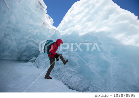 Woman hiker hiking in winter hugh glacier mountain,China Woman hiker hiking in winter hugh glacier mountain,China 102878998