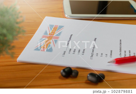 English test with red pen and tab on wooden desk English test with red pen and tab on wooden desk 102879881