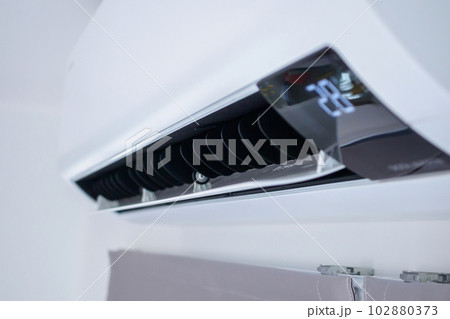 Air conditioner on white wall room interior background Air conditioner on white wall room interior background 102880373