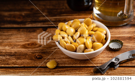 salted Lupin Beans with beer on table with copy space 102881594