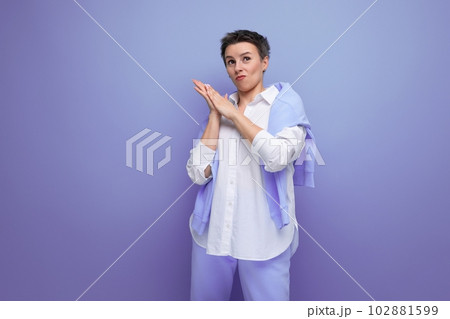 portrait of an informal young brunette woman with a short haircut in a white shirt 102881599