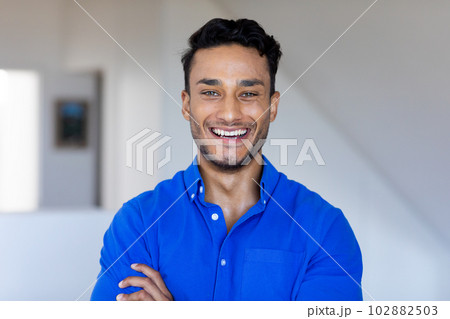 Portrait of happy biracial man looking at camera and smiling 102882503