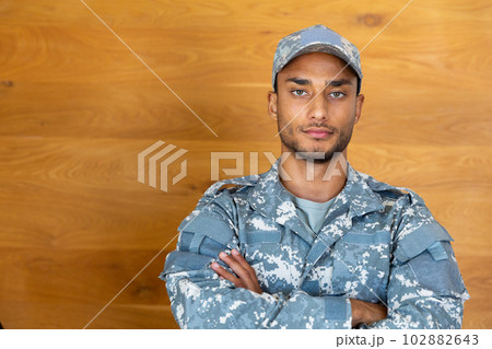 Portrait of biracial male soldier wearing military uniform and cap, looking at camera, copy space 102882643