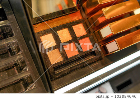 Cosmetics and make-up eyeshadows on a shop window. Cosmetics and make-up eyeshadows on a shop window. 102884646