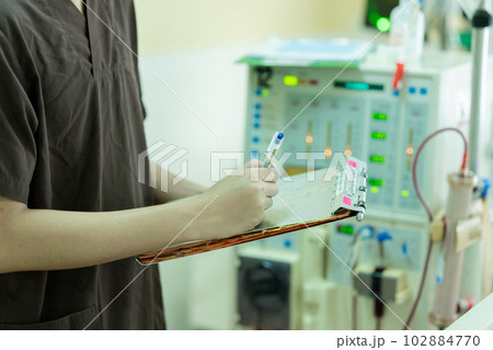 The specialist aThe specialist are checking continuous renal replacement therapy equipment and inre checking continuous renal replacement therapy equipment and injection pump and hemodialysis machine. 102884770