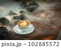 Background Coffee cup and beans on old kitchen table.  102885572