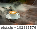 Background Coffee cup and beans on old kitchen table.  102885576