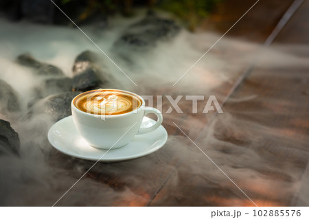 Background Coffee cup and beans on old kitchen table.  102885576