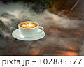 Background Coffee cup and beans on old kitchen table.  102885577