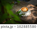 Background Coffee cup and beans on old kitchen table.  102885580