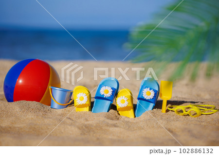 Kids flip-flops, beach ball and snorkel on the sand. Summer vacation concept 102886132