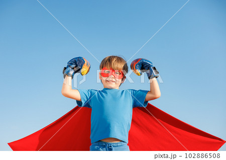 Superhero child against summer blue sky Superhero child against summer blue sky 102886508