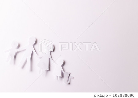 White paper cut out of family with two children and cat and copy space on white background White paper cut out of family with two children and cat and copy space on white background 102888690