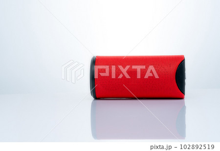 Wireless portable speaker isolated on white background. Red Digital portable speakers. Small sound music box speaker. Modern design mini portable Wireless loudspeaker. Digital wireless technology. 102892519