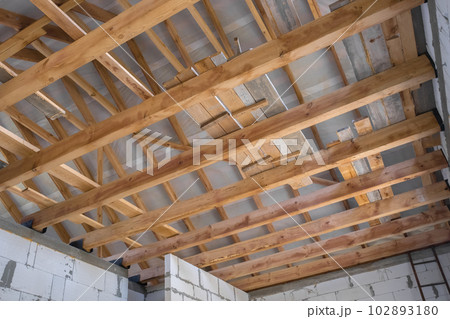 New construction of the house. Construction with wooden roof, pillar and frame beams. 102893180