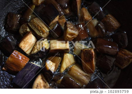 Stewed eggplant fried in sunflower oil in a pan close-up 102893759
