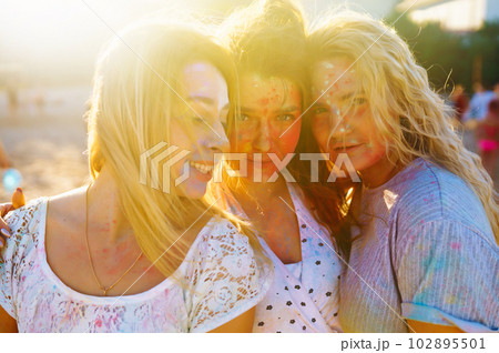 Group of friends have fun at holi festival. Traditional spring holiday. Friendship, Togetherness. Group of friends have fun at holi festival. Traditional spring holiday. Friendship, Togetherness. 102895501