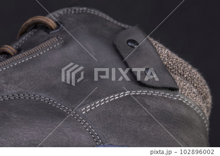 Part of a leather boot close-up. A fragment of the texture of leather shoes. 102896002