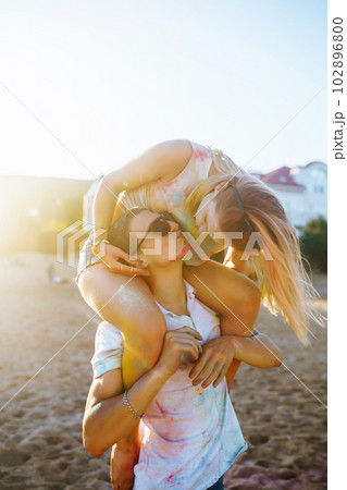 Beautiful couple enjoy each other on Holi festival Friendship, Leisure, Vacation, Togetherness. Beautiful couple enjoy each other on Holi festival Friendship, Leisure, Vacation, Togetherness. 102896800