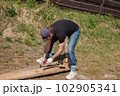 Man builds sections of fence around his yard out of planks 102905341