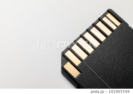 The contact group of the SD flash memory card is black on a gray background. macro close-up The contact group of the SD flash memory card is black on a gray background. macro close-up 102905594