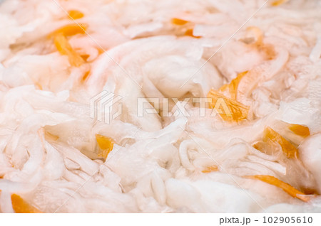 macro shot of sauerkraut. Close-up view of a piece of sour sauerkraut with carrots. Home salad. fermented food 102905610