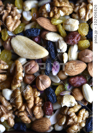 Assorted nuts in a box close-up. Delicious different nuts in a box. 102906826