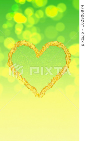 Golden Heart on a Green-Yellow Bokeh Background 102906974