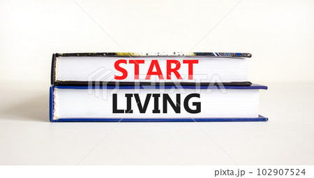Start living symbol. Concept words Start living on beautiful books. Beautiful white table white background. Business and Start living concept. Copy space. 102907524