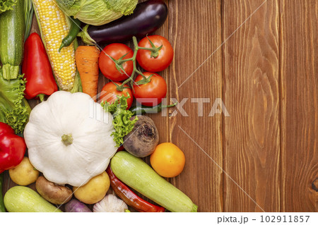 Top view of various vegetables on a wooden table with copy space. Top view of various vegetables on a wooden table with copy space. 102911857