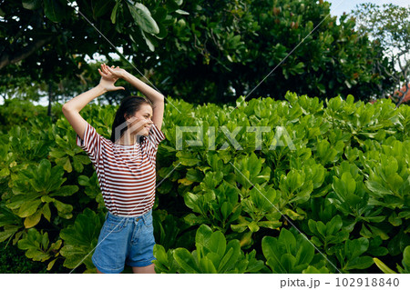 smiling woman t-shirt park summer walk bali lifestyle nature freedom beautiful 102918840