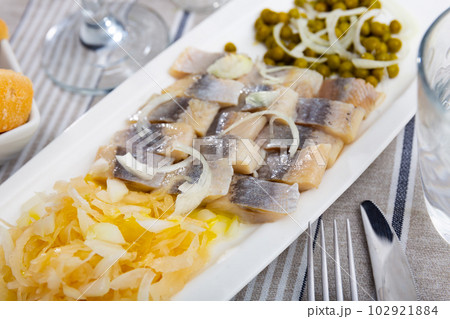 Light salted herring with marinated cabbage and green peas 102921884