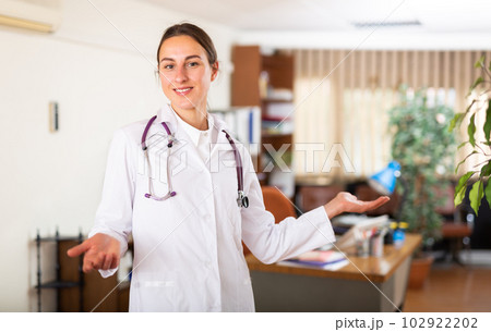 Woman doctor wear white medical uniform and stethoscope look at camera posing in clinic 102922202