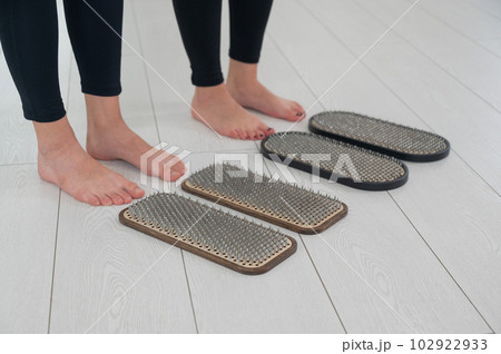 Close-up on the feet of two women in front of the sadhu's nails. Close-up on the feet of two women in front of the sadhu's nails. 102922933