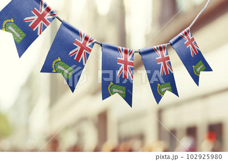 A garland of British Virgin Islands national flags on an abstract blurred background 102925980