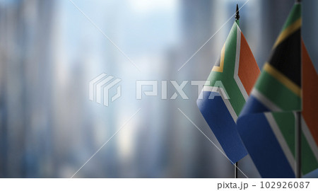 Small flags of the South Africa on an abstract blurry background 102926087