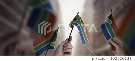 A group of people holding small flags of the South Africa in their hands 102926132
