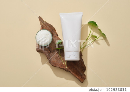 A tree branch with a tube and mini glass petri dish of foams placed on. Gotu kola (Centella asiatica) can moisturize dry skin conditions A tree branch with a tube and mini glass petri dish of foams placed on. Gotu kola (Centella asiatica) can moisturize dry skin conditions 102928851