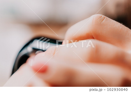 Woman hand using smart watches mobile app with touch screen. New gadget to stay connected to internet. Stylish touchscreen wrist watches with navigation mobile application. Close up. Selective focus Woman hand using smart watches mobile app with touch screen. New gadget to stay connected to internet. Stylish touchscreen wrist watches with navigation mobile application. Close up. Selective focus 102930840