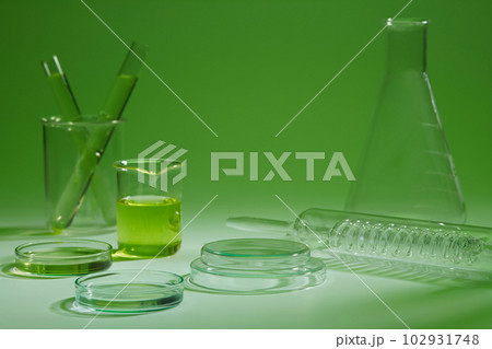 Many laboratory glassware are arranged over a green background. Concept scene stage showcase for product advertising 102931748