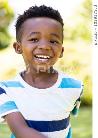 Closeup portrait of cheerful african american cute boy smiling and looking at camera 102937533
