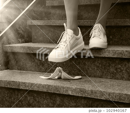Foot stepping on a banana peel on steps Foot stepping on a banana peel on steps 102940167