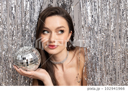Young woman with disco ball, close up Young woman with disco ball, close up 102941966