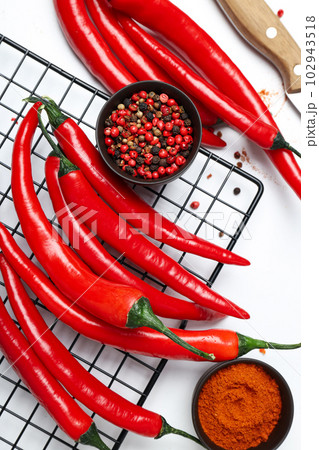Concept of hot and spicy ingredients - red hot chili pepper Concept of hot and spicy ingredients - red hot chili pepper 102943518