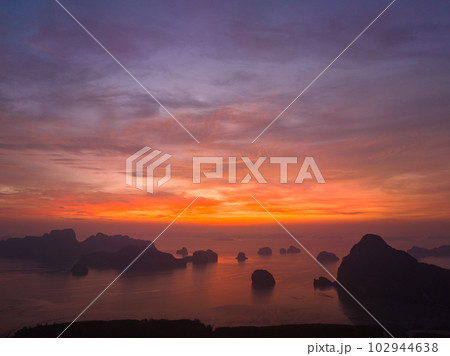 aerial view Amazing light of nature cloudscape sky above Samed Nang Chee Phang Nga archipelago. .Imagine a fantasy bright red sky at sunrise from a bird's eye view..tropical landscape background. 102944638