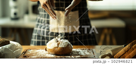 Shot of unrecognizable baker in apron preparing dough pastry with white flour 102946821