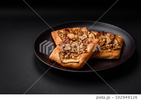 Delicious fresh sweet pie or pizza with pear, brie cheese, honey and nuts Delicious fresh sweet pie or pizza with pear, brie cheese, honey and nuts 102949126