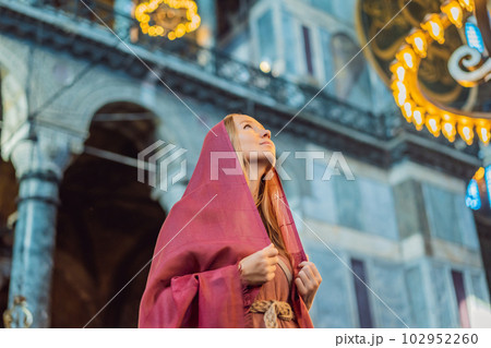 Woman tourist enjoying Hagia Sofia, Ayasofya interior in Istanbul, Turkey, Byzantine architecture, city landmark and architectural world wonder. Turkiye 102952260